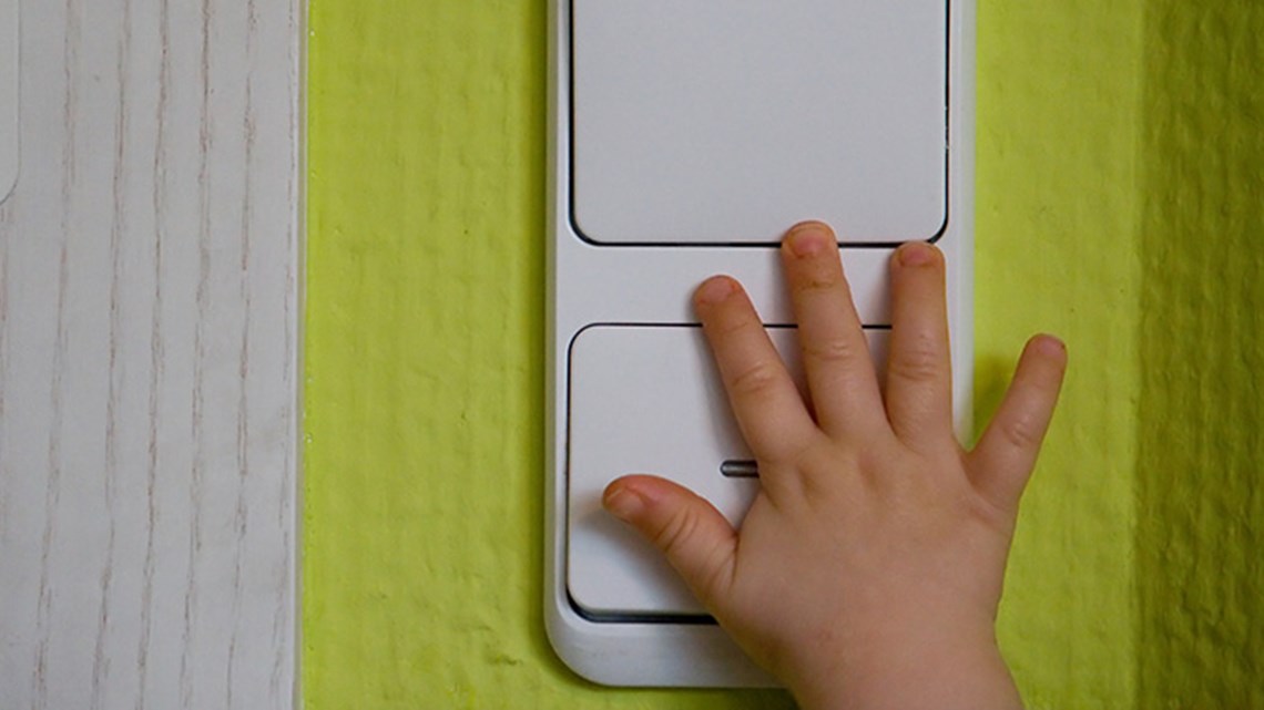 Kid hand touching switch