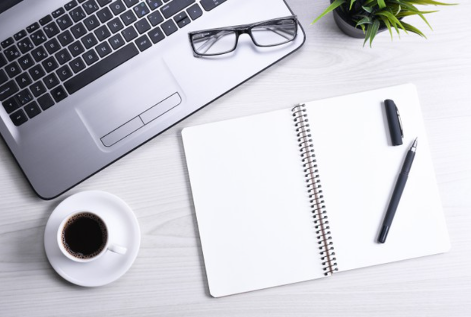 Close up of a desk with laptop and books