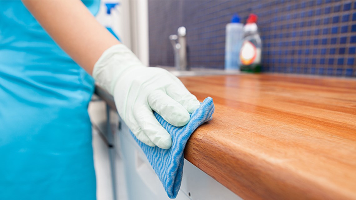 Hand cleaning kitchen counter